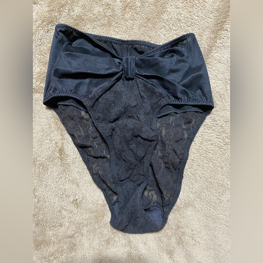 Black panties with bow. These are shape wear. Never worn.